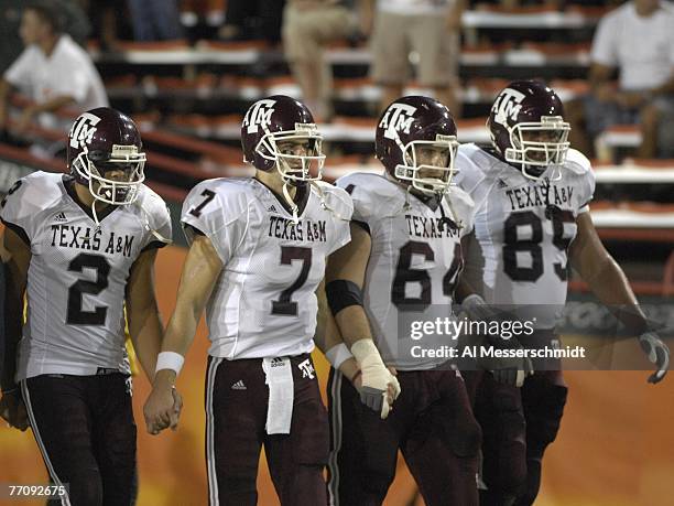 Tight end Martellus Bennett and quarterback Stephen McGee of Texas A&M Aggies walk hand-in-hand to the coin toss before play against the University...