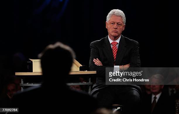 Former president Bill Clinton listens as he receives a report on progress on the final day of the Clinton Global Initiative annual meeting September...