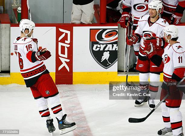 Andrew Ladd of the Carolina Hurricanes reacts toward Scott Walker and Justin Williams after Ladd scored the winning goal as the ninth shooter in a...