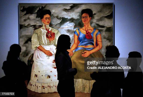 People look at the 1939 painting "Las Dos Fridas" , by Mexican artist Frida Kahlo on exhibit during the World Forum of Culturew 28 September, 2007 in...