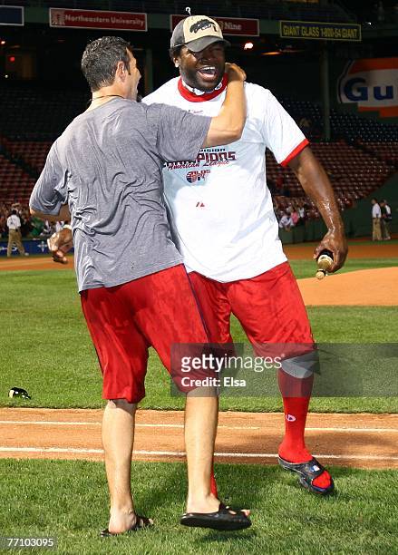 Mike Lowell and David Ortiz of the Boston Red Sox celebrate after they defeated the Minnesota Twins 5-2 and the New York Yankees lost to the...