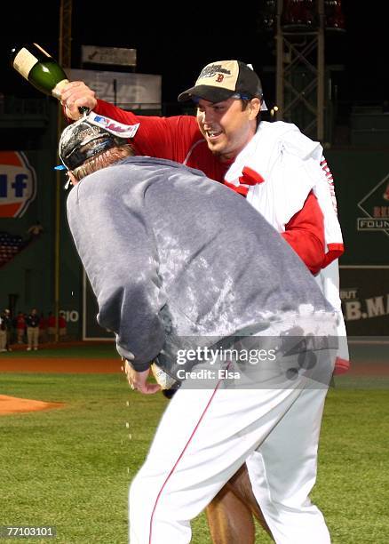 Josh Beckett of the Boston Red Sox soaks teammate Kurt Schilling after they defeated the Minnesota Twins 5-2 and the New York Yankees lost to the...