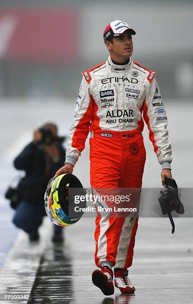 Adrian Sutil of Germany and Spyker F1 walks in the pitlane prior to qualifying for the Japanese Formula One Grand Prix at the Fuji Speedway on...