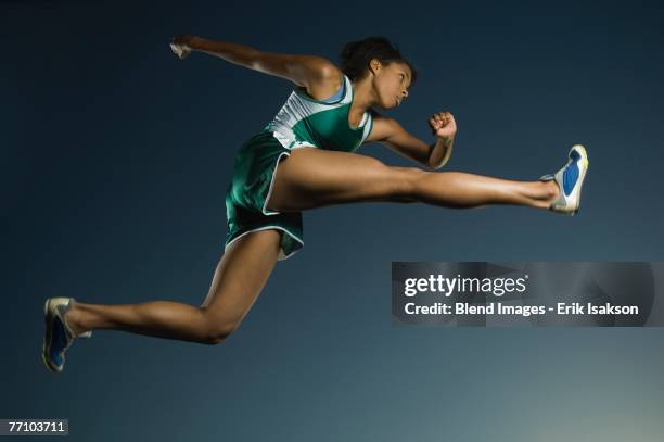 african american female athlete jumping - woman long jump stock-fotos und bilder