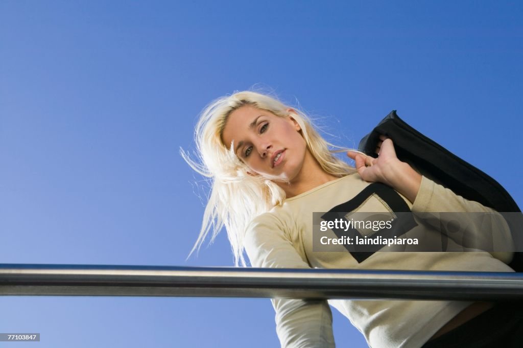 Young woman looking over railing