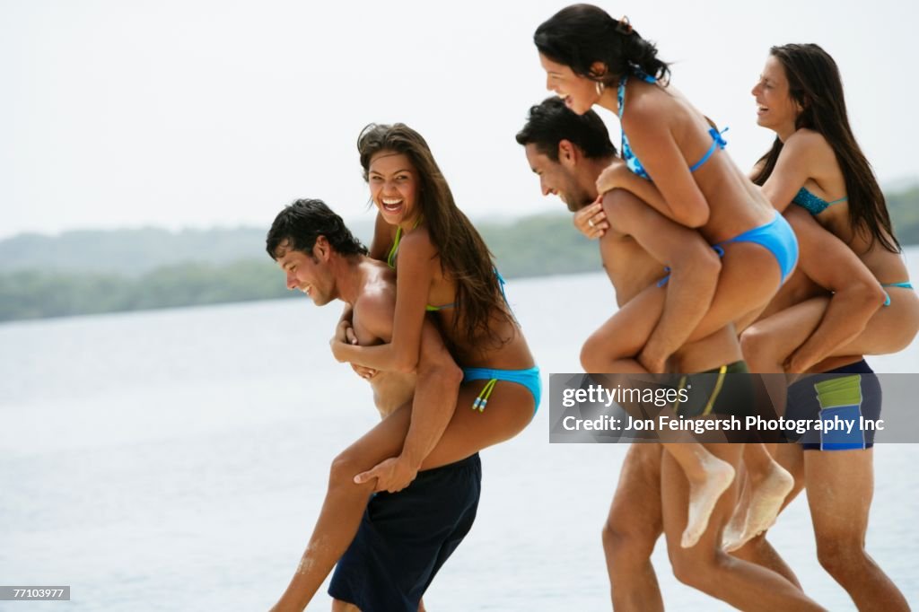 South American couples playing at beach