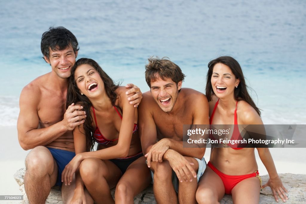 South American friends laughing at beach