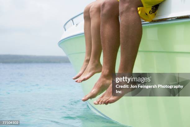 south american couple dangling feet off of boat - girlfriend feet stock pictures, royalty-free photos & images