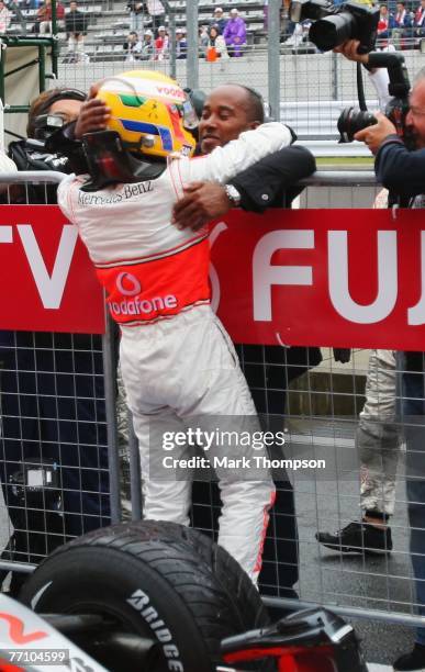 Lewis Hamilton of Great Britain and McLaren Mercedes celebrates with his father Anthony Hamilton in parc ferme after taking pole position during...