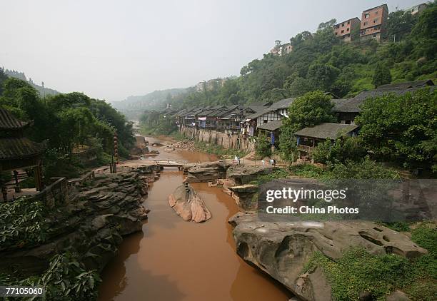 View of houses along a river at the ancient Zhongshan Township on September 28, 2007 in Chongqing Municipality, China. History of the town dates back...