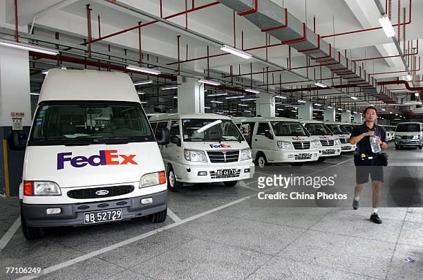Worker walks past mail pickup and delivery vans during a strike at the Chegong Temple Operation Station of Federal Express September 28, 2007 in...