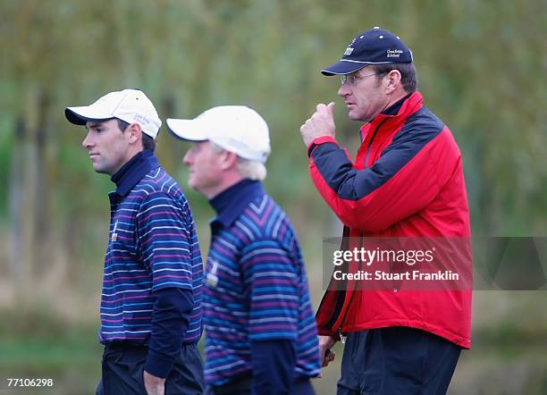 Simon Dyson and Oliver Wilson of The Great Britain and Ireland Team with Captain Nick Faldo during the third day morning greensomes at the Seve...