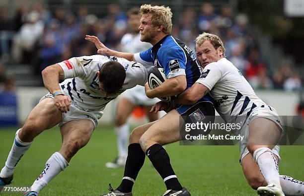 Bath's Michael Stephenson ia tackled by Chris Bell and Lee Thomas of Sale during the Guinness Premiership rugby match between Bath and Sale Sharks,...