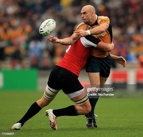 Australian scrum half Sam Cordingley off loads in the tackle during the IRB Rugby World Cup Pool B match between Australia and Canada at the Stade...