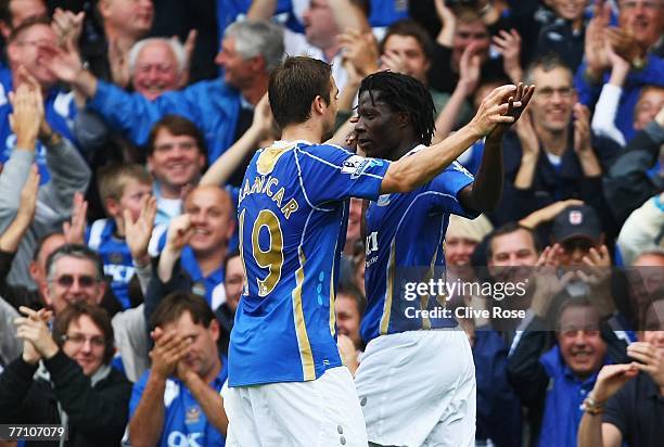 Benjani of Portsmouth celebrates his goal with teammate Niko Kranjcar during the Barclays Premier League match between Portsmouth and Reading at...