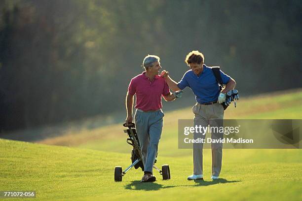 golf, players walking on fairway - course caddie imagens e fotografias de stock