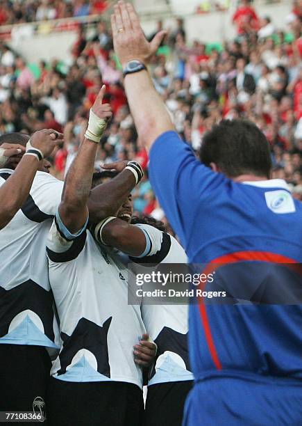 Graham Dewes of Fiji celebrates as Referee Stuart Dickinson of Australia awards the match winning try the match winning try during the Rugby World...