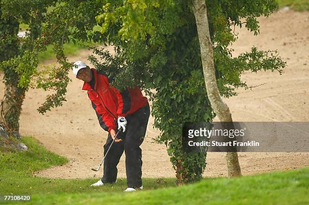 Bradley Dredge of The Great Britain and Ireland Team plays a shot under the trees on the 11th hole during the third day afternoon foursomes at the...