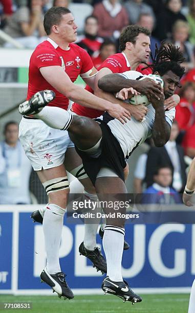 Seru Rabeni of Fiji claims a high ball as he is tackled by Ian Evans and Mark Jones of Wales during the Rugby World Cup 2007 Pool B match between...