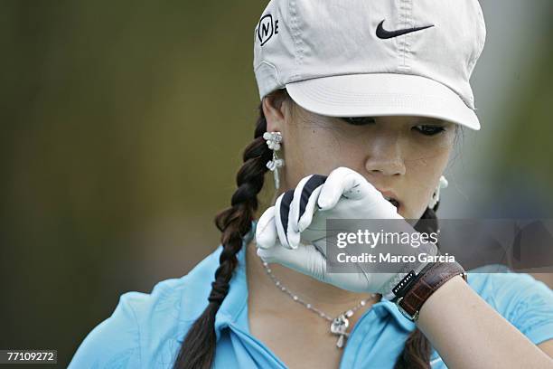 Michelle Wie pulls off her glove on the first green during the first round of the Sony Open held at the Waialae Country Club in Honolulu, Hawaii on...