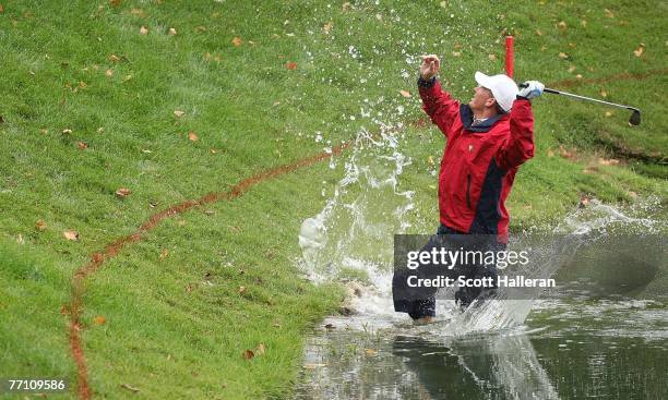 Woody Austin of the U.S. Team plays his second shot from the water at the par 4, 14th hole during the round two fourball matches at the Presidents...