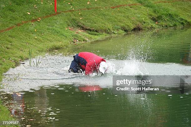 Woody Austin of the U.S. Team plays his second shot from the water at the par 4, 14th hole during the round two fourball matches at the Presidents...