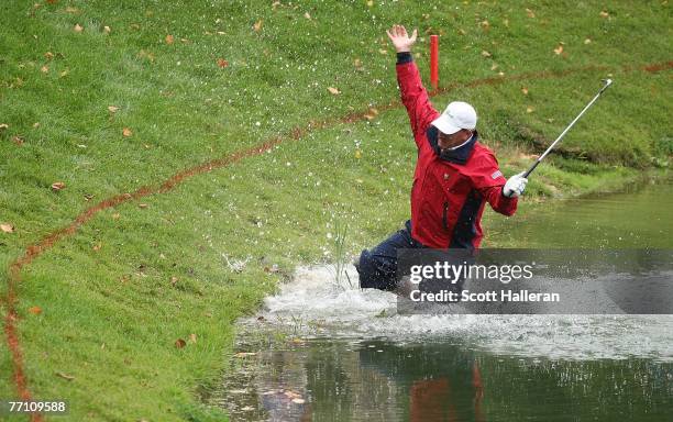 Woody Austin of the U.S. Team plays his second shot from the water at the par 4, 14th hole during the round two fourball matches at the Presidents...