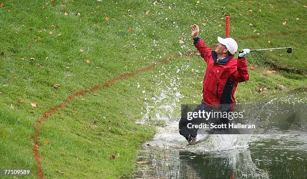 Woody Austin of the U.S. Team plays his second shot from the water at the par 4, 14th hole during the round two fourball matches at the Presidents...