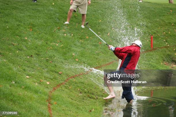 Woody Austin of the U.S. Team plays his second shot from the water at the par 4, 14th hole during the round two fourball matches at the Presidents...