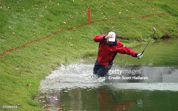 Woody Austin of the U.S. Team plays his second shot from the water at the par 4, 14th hole during the round two fourball matches at the Presidents...