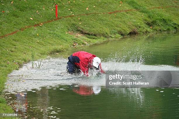 Woody Austin of the U.S. Team plays his second shot from the water at the par 4, 14th hole during the round two fourball matches at the Presidents...