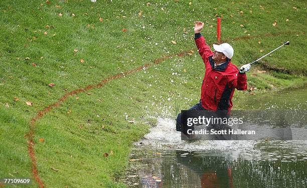 Woody Austin of the U.S. Team plays his second shot from the water at the par 4, 14th hole during the round two fourball matches at the Presidents...