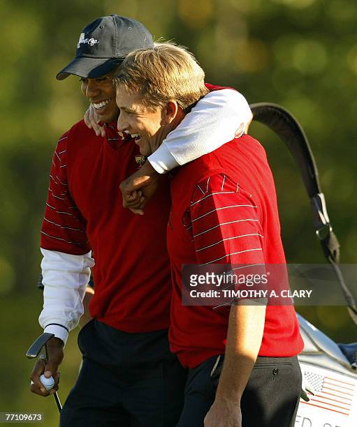 United States golfers Tiger Woods and David Toms hug after winning their match on the 15th hole during the Four-Ball Matches of The Presidents Cup 29...