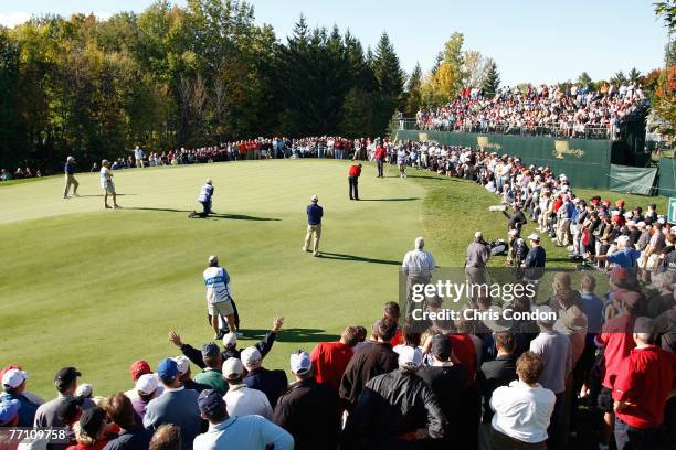 Spectators crowd the green at during the Saturday afternoon four-ball round of competition for The Presidents Cup on September 29 at The Royal...