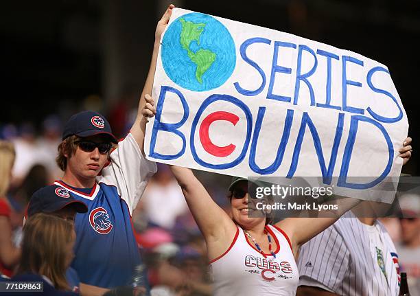 Fans of the Chicago Cubs cheer on their team clinching the National League West division during against the Cincinnati Reds at Great American...