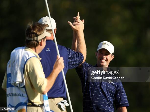 Mike Weir and Ernie Els of the International Team celebrate a winning birdie by Weir on the 15th hole during the 3rd day afternoon fourball matches...
