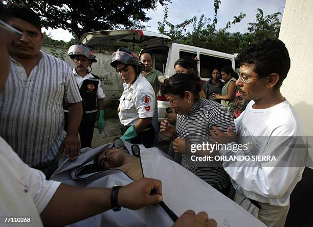 The corpse of a member of the youngster gang Salvatrucha is recognised by a family member in the morgue of El Boqueron high security prison 29...