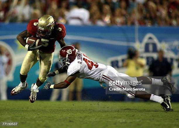Receiver Preston Parker of the Florida State Seminoles catches a pass in front of Rashad Johnson during his teams 21-14 victory September 29, 2007 at...