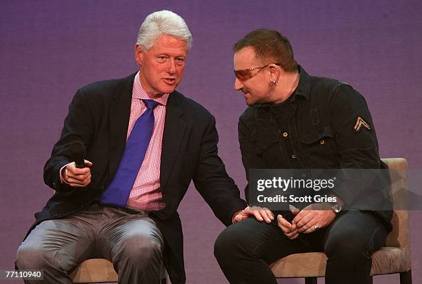 Former President Bill Clinton and musician Bono appear on stage during "Giving - Live At The Apollo" presented by the MTV and Clinton Global...