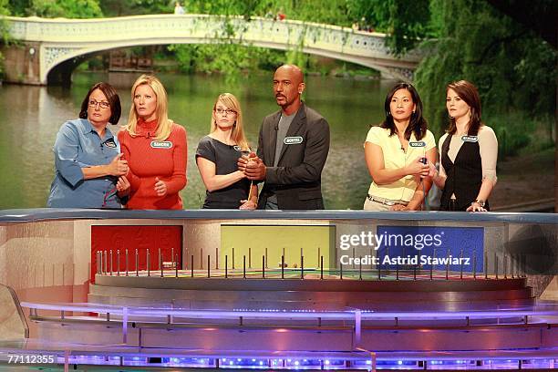 Theresa Feeney, actress Sandra Lee; April Baker, actor Montel Williams, Dolly DeSantis and actress Kristan Cunningham guess at a puzzle during a...