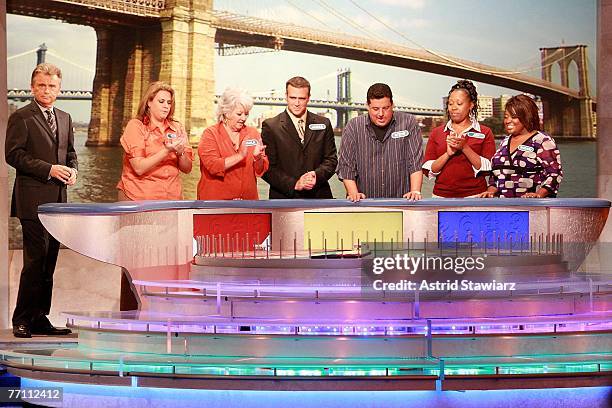 Host Pat Sajak greets Tara Carroll, Paula Deen, James Thompson, actor Steve Schirripa, Joy Bryant and actress Sherri Shepherd during a taping of...