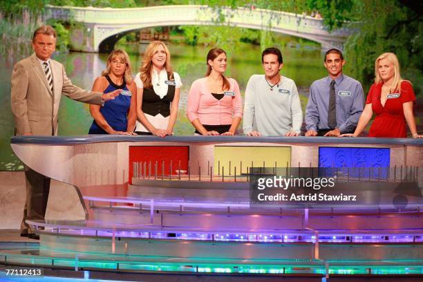 Host Pat Sajak greets Nancy Kaufman, actress Paige Hemmis, Susan Moran, actor Jeff Probst, Nick Giovine and actress Alison Sweeney during a taping of...