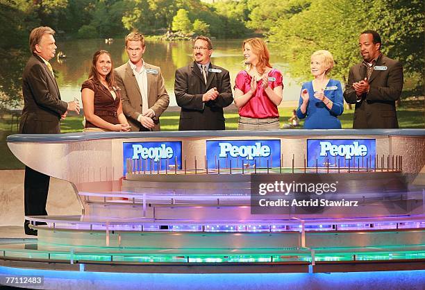 Host Pat Sajak greets Megan Sippey, actor Neil Patrick Harris, Seth Ramus, actress Diane Neal, Diana Mallon and actor Robert Gossett during a taping...