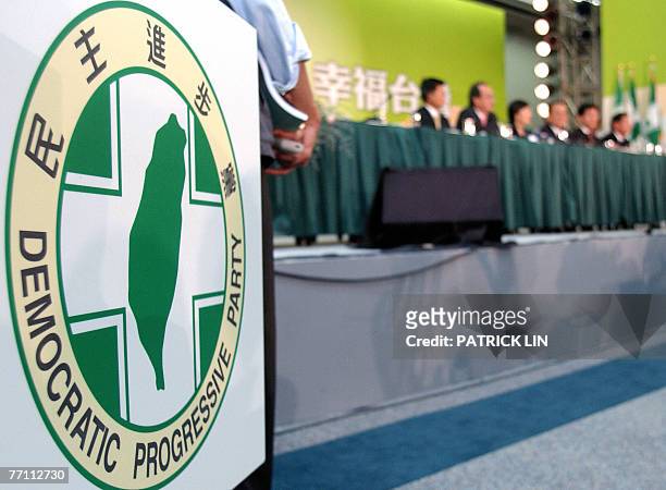 This photo shows the logo of Taiwan's ruling Democratic Progressive Party while a group of top party officials attend a press conference in Taipei,...