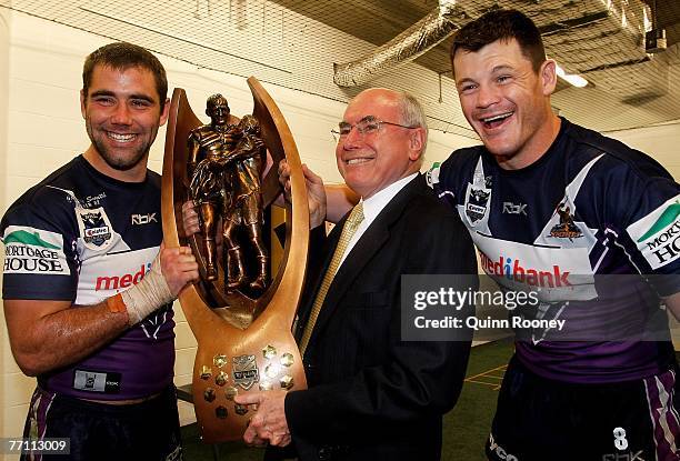 Cameron Smith and Ben Cross of the Storm pose for a photo with Prime minister John Howard after winning the NRL Grand Final match between the...