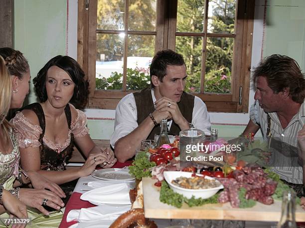Miroslav Klose, his wife Sylwia and Bernd Dreher chat at the Kaefer?s party tent for a day at the Oktoberfest on September 30, 2007 in Munich,...