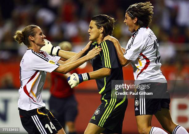 Nadine Angerer of Germany is congratulated by Simone Laudehr and Ariane Hingst after saving a penalty from Marta Vieira Da Silva of Brazil during the...