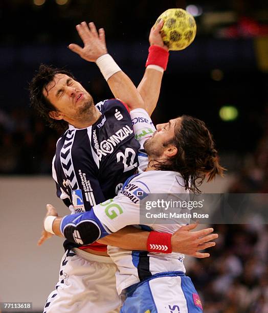 Marcin Lijewski of Flensburg is attacked by Bertrand Gille of Hamburg during the Bundesliga Handball match between HSV Hamburg and SG...