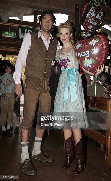 Luca Toni and his girlfriend Marta Cecchetto arrive at the Kaefer?s party tent for a day at the Oktoberfest on September 30, 2007 in Munich, Germany.