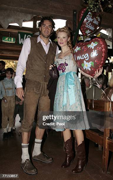 Luca Toni and his girlfriend Marta Cecchetto arrive at the Kaefer?s party tent for a day at the Oktoberfest on September 30, 2007 in Munich, Germany.